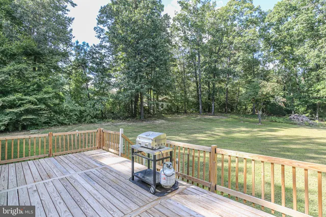 a view of a wooden deck with a yard