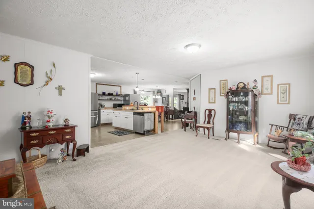 a living room with lots of furniture and clutter