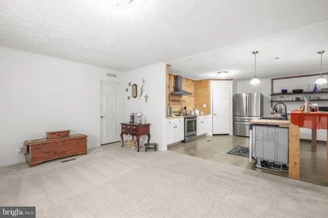 a view of kitchen with furniture and refrigerator