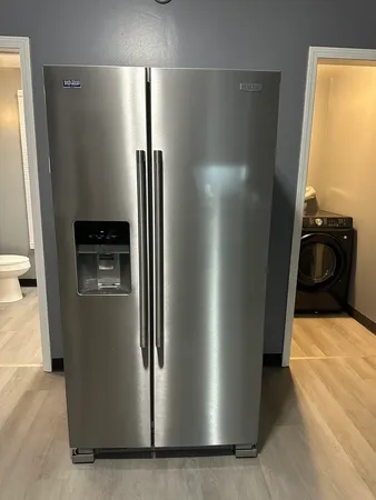 a kitchen with metallic refrigerator freezer and a dishwasher