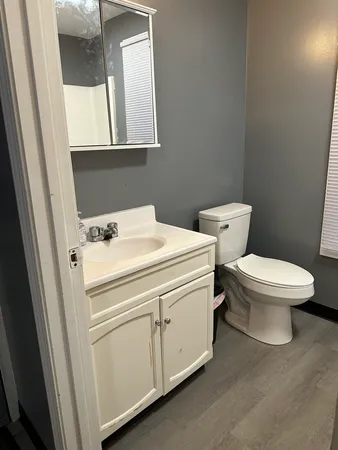 a white toilet sitting next to a white sink