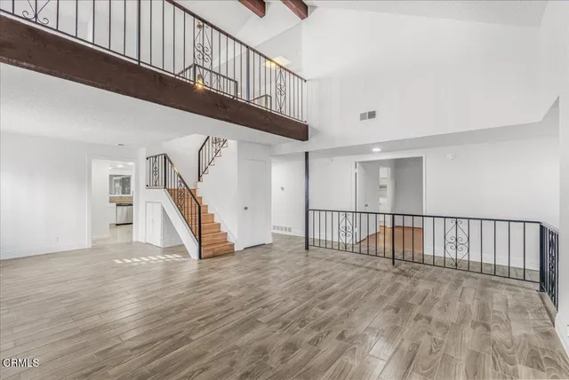 a large kitchen with granite countertop a sink a stove a dining table and chairs