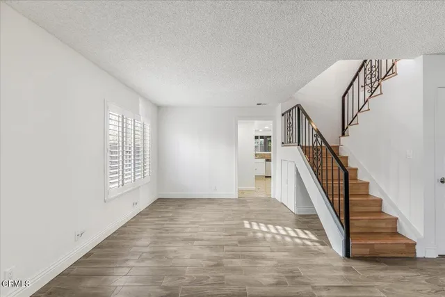 a kitchen with granite countertop a sink stainless steel appliances and white cabinets