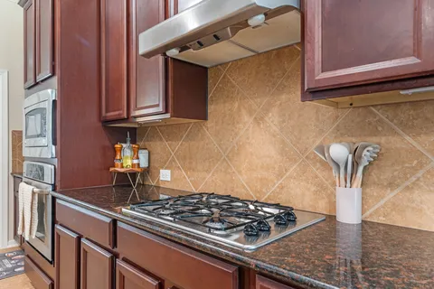 a kitchen with stainless steel appliances granite countertop a sink and cabinets
