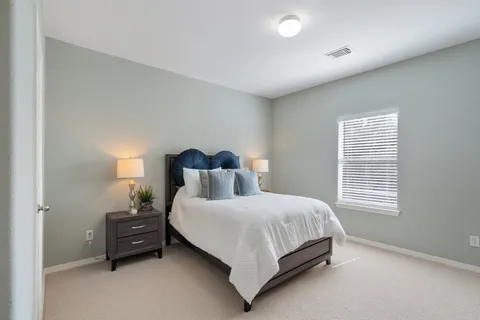 a bedroom with a bed and a dresser