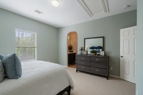 a bedroom with a bed and a window