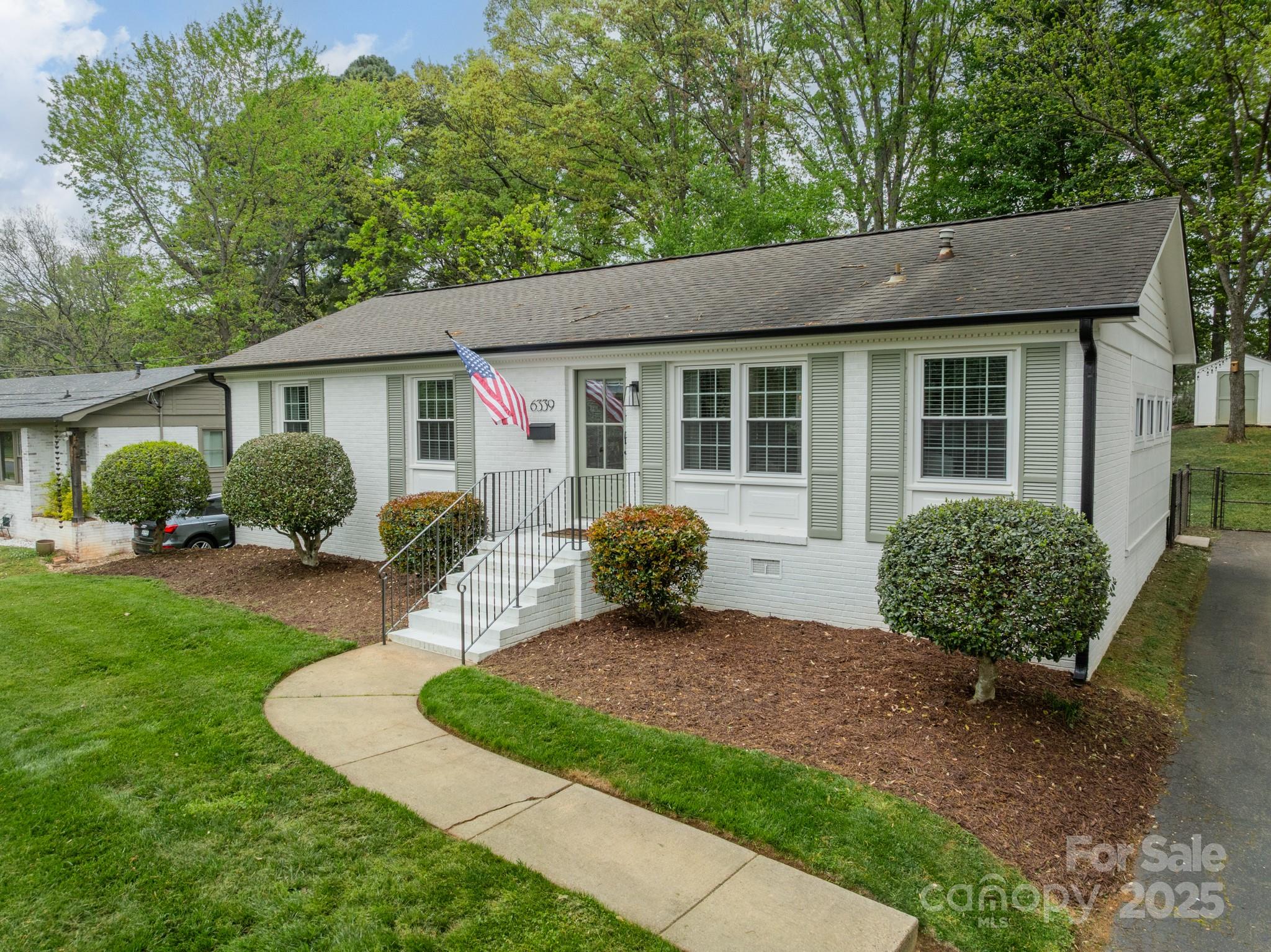 a view of a house with a yard and plants