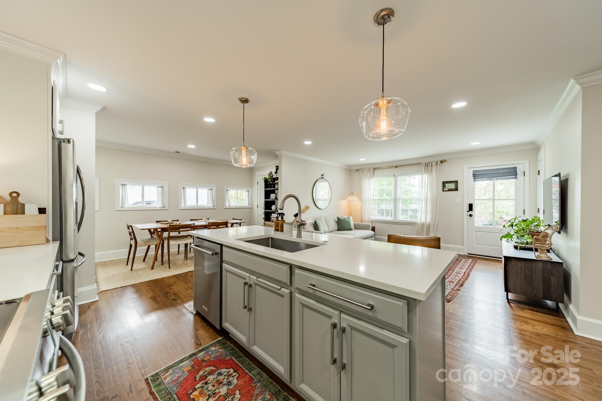 6339 Montpelier Road Charlotte, NC 28210 - Photo 11 of 35 a kitchen with counter top space sink stove and wooden floor