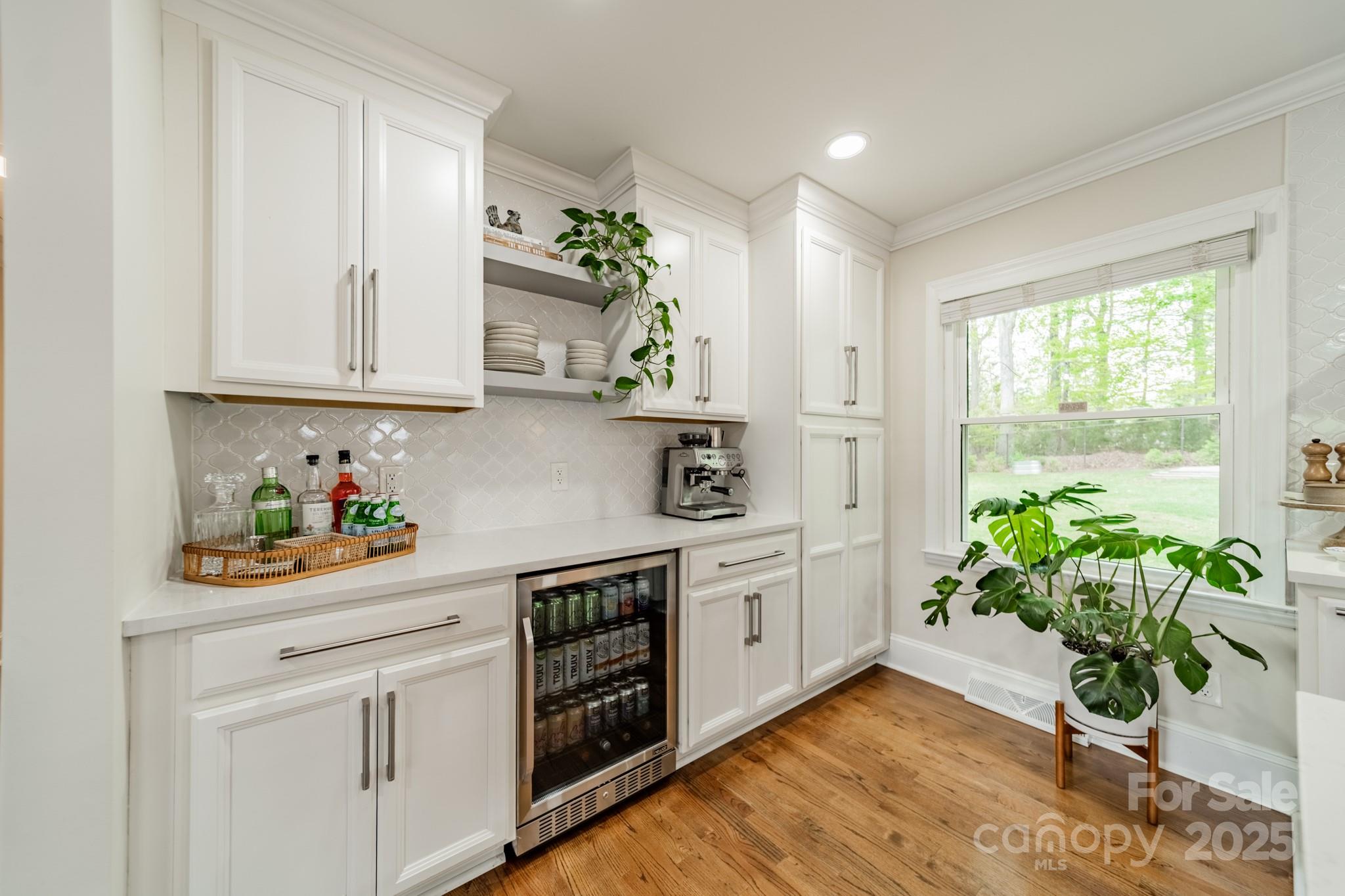 6339 Montpelier Road Charlotte, NC 28210 - Photo 13 of 35 a room with stainless steel appliances white cabinets and a window