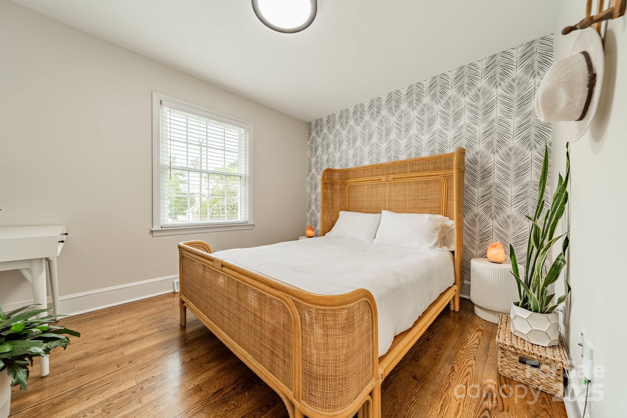 6339 Montpelier Road Charlotte, NC 28210 - Photo 16 of 35 a bed sitting in a bedroom next to a window