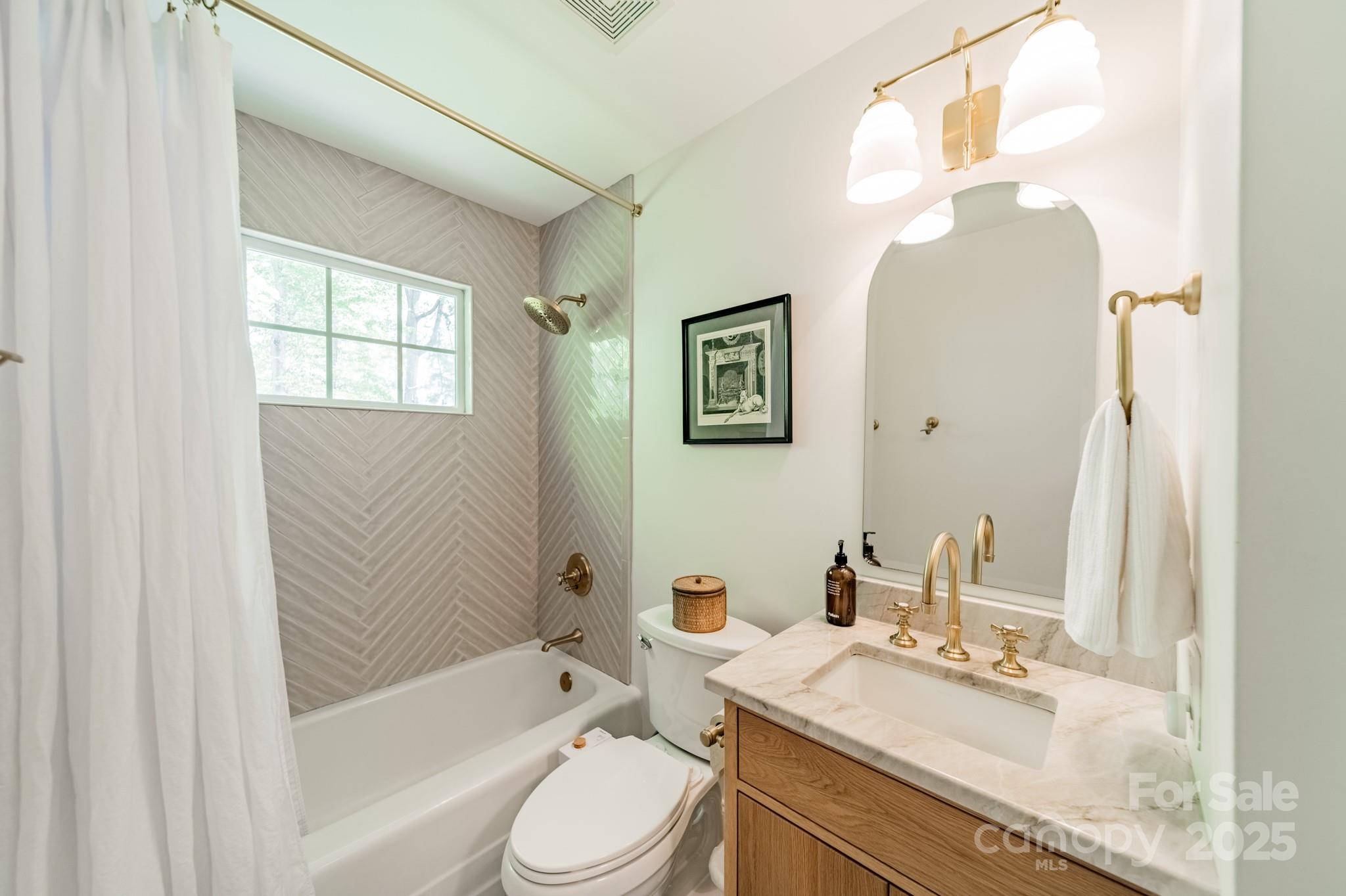 6339 Montpelier Road Charlotte, NC 28210 - Photo 18 of 35 a bathroom with a granite countertop sink toilet mirror and bathtub