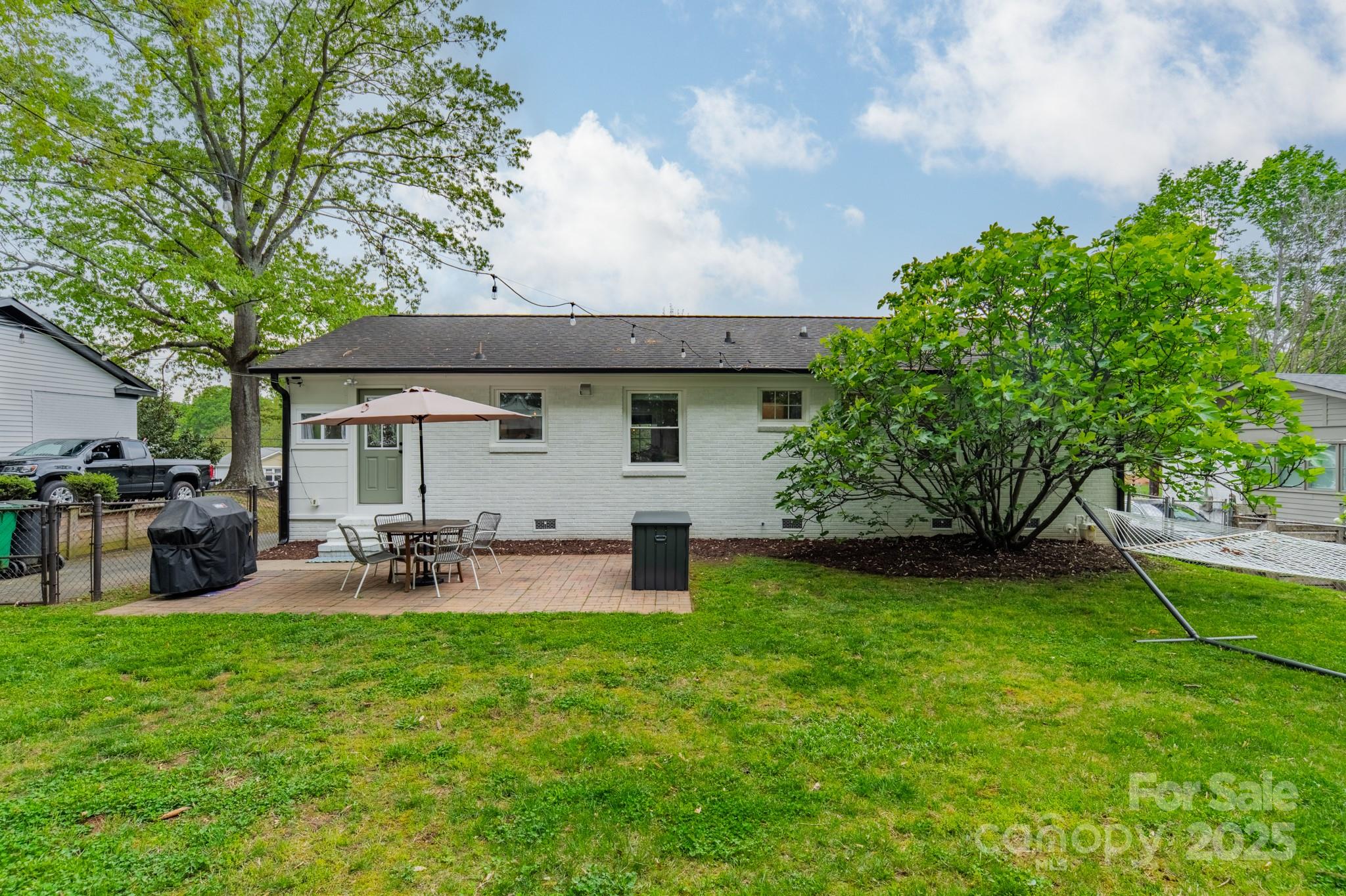 6339 Montpelier Road Charlotte, NC 28210 - Photo 25 of 35 a view of a house with backyard and sitting area