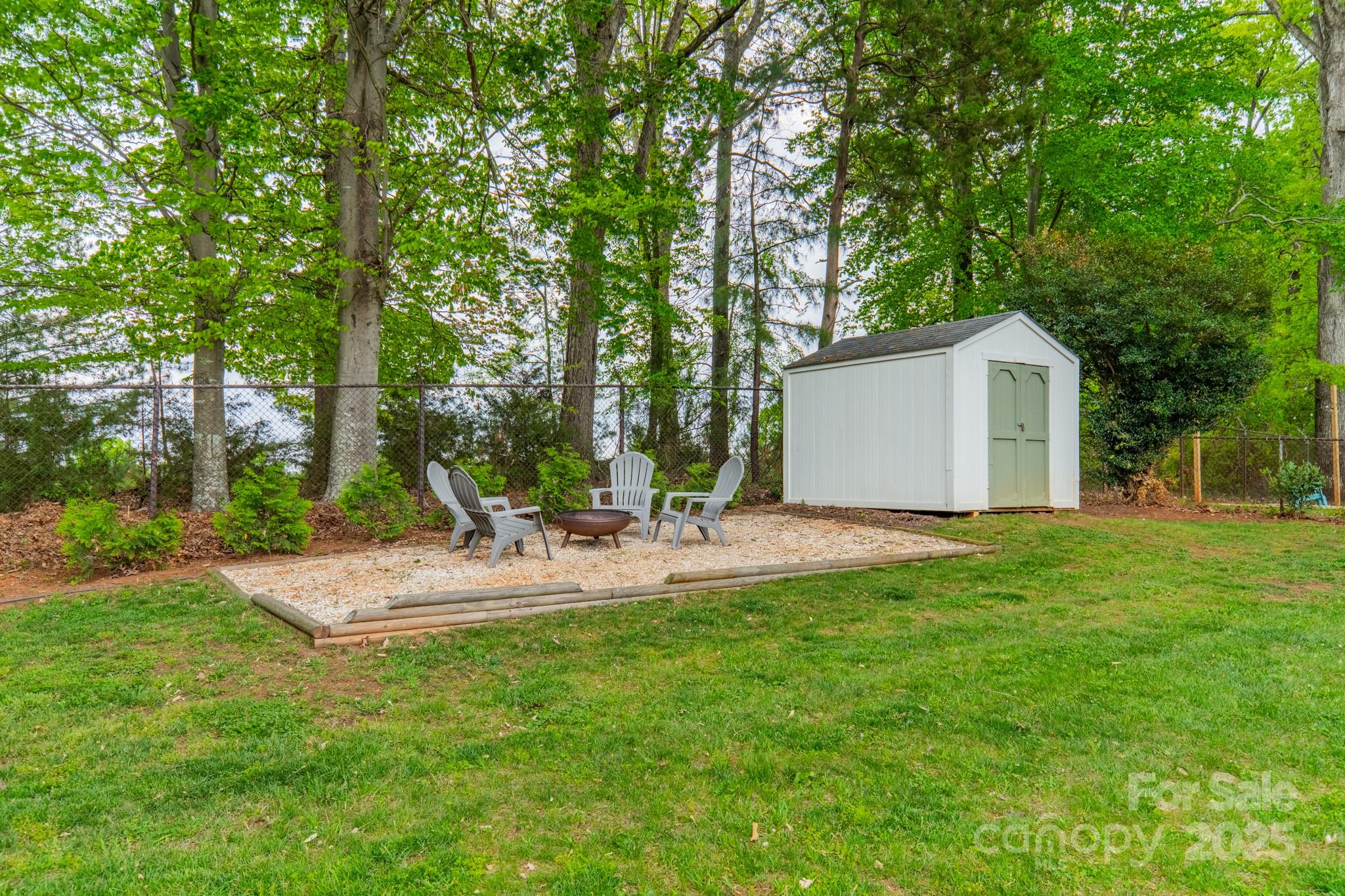 6339 Montpelier Road Charlotte, NC 28210 - Photo 28 of 35 a view of a house with backyard and trees