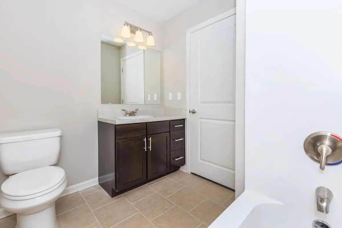 6454 Airline Highway Baton Rouge, LA 70805 - Photo 14 of 16 a bathroom with a sink a toilet and a mirror