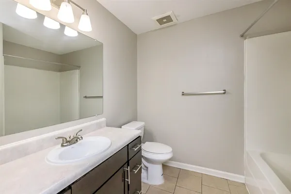 a bathroom with a sink mirror vanity and toilet