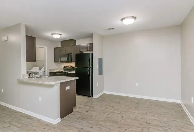 a kitchen with kitchen island a sink appliances and cabinets