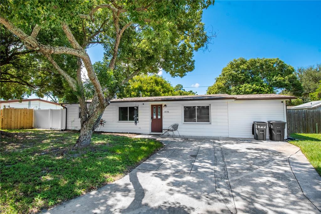 4154 Highland Loop New Port Richey, FL 34652 - Photo 1 of 1 a house with trees in the background