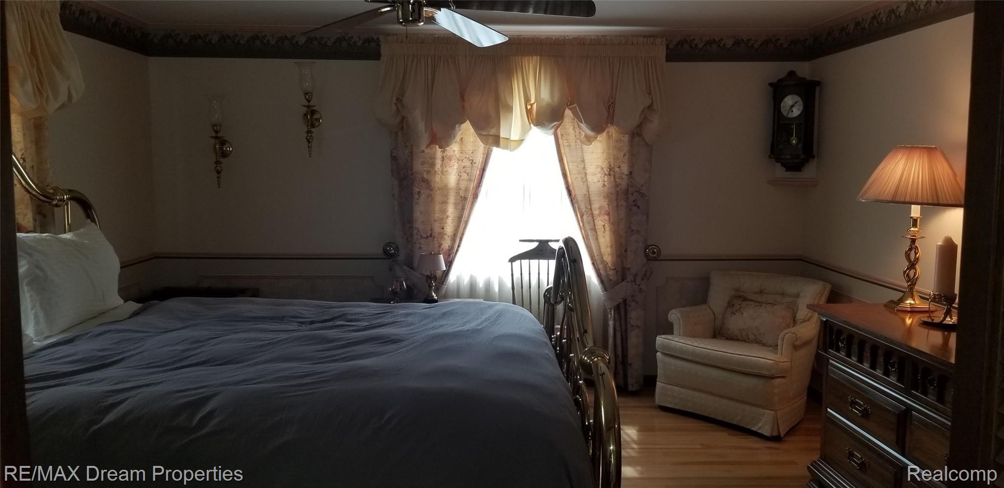 6533 Flintlock Ridge Utica, MI 48317 - Photo 18 of 53 SPACIOUS MASTER SUITE WITH GORGEOUS HARDWOOD FLOORING NEWER CEILING FAN, WALK IN CLOSET, MASTER BATH, LARGE DRESSING AREA, AND BALCONY OVERLOOKING REAR YARD