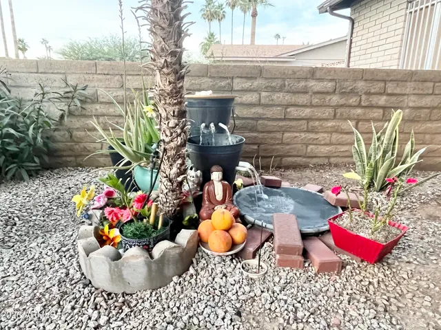 a table with chairs and potted plants