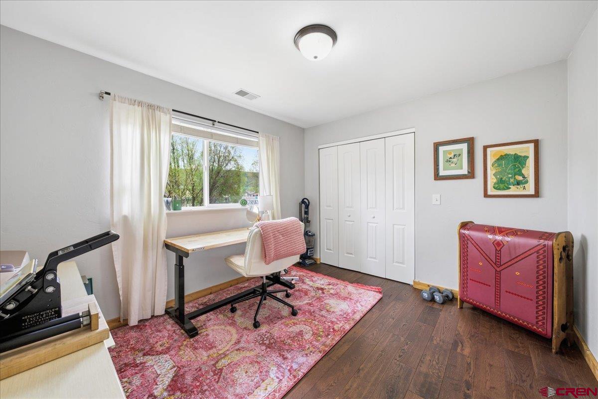 520 Redcliff Circle, Unit G203 Ridgway, CO 81432 - Photo 14 of 25 a living room with furniture rug and window