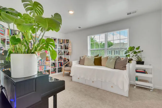 a living room with furniture flowerpot and a window