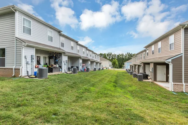a front view of a building with a garden