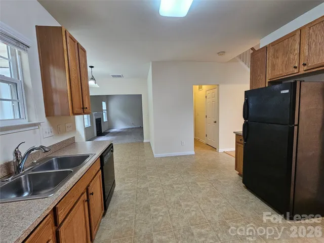 a kitchen with a sink stove and refrigerator