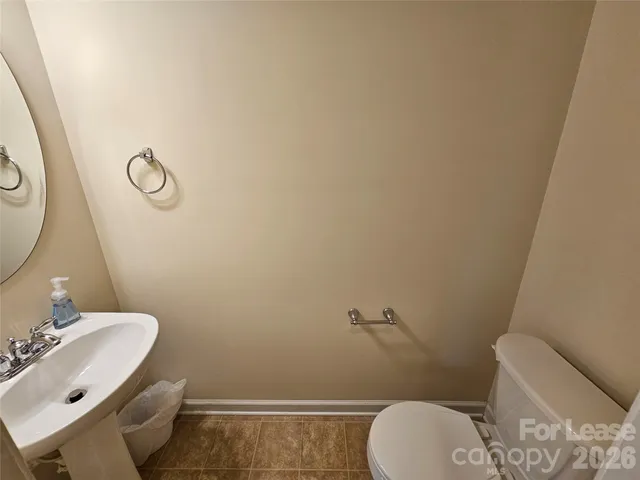 a bathroom with a toilet and a mirror