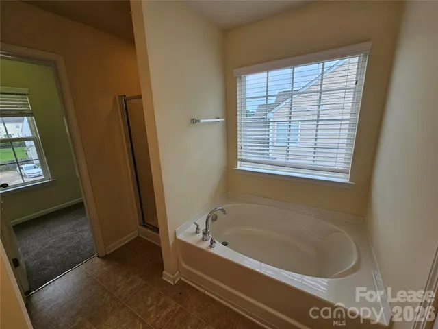 a spacious bathroom with a double vanity sink and a mirror