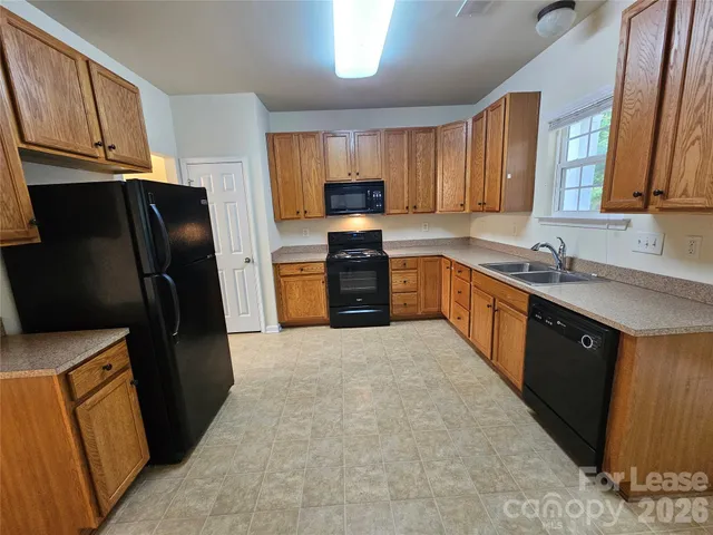 a kitchen with a refrigerator and a sink