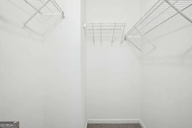 a view of entryway and kitchen with wooden floor