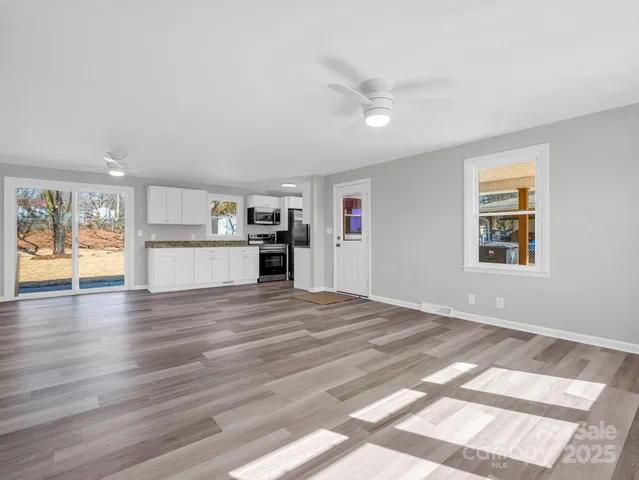 a view of a kitchen with wooden floor and a kitchen