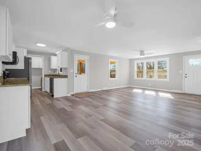 a view of a kitchen with a sink cabinets and wooden floor