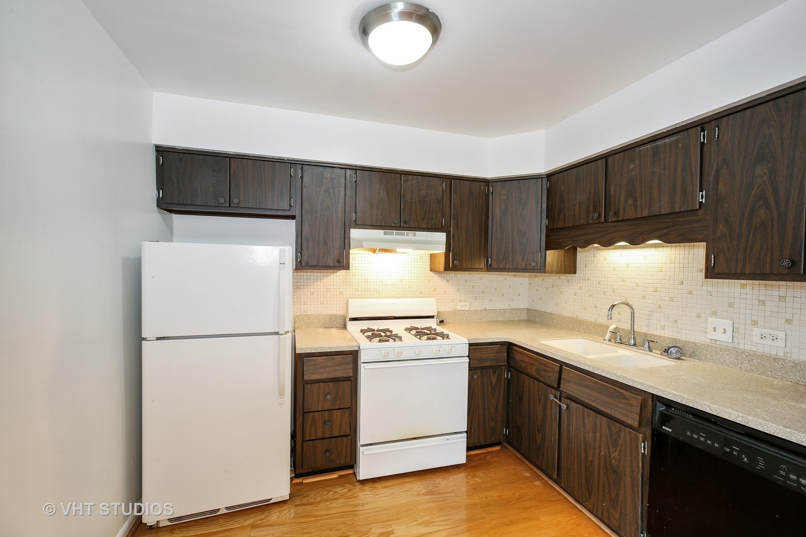 2250 Heather Road Homewood, IL 60430 - Photo 3 of 10 a kitchen with a sink a stove a refrigerator and cabinets