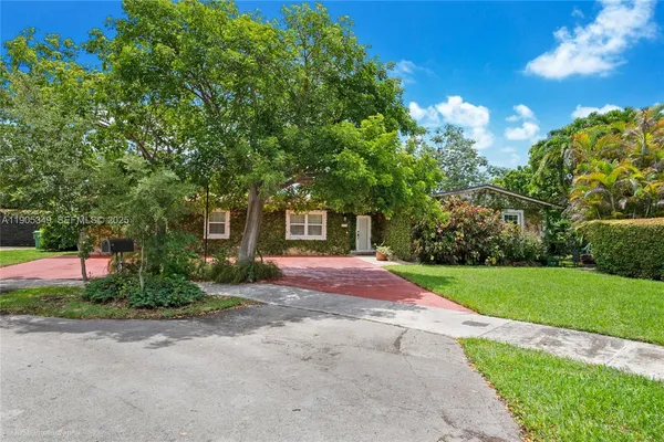 a front view of a house with yard and green space