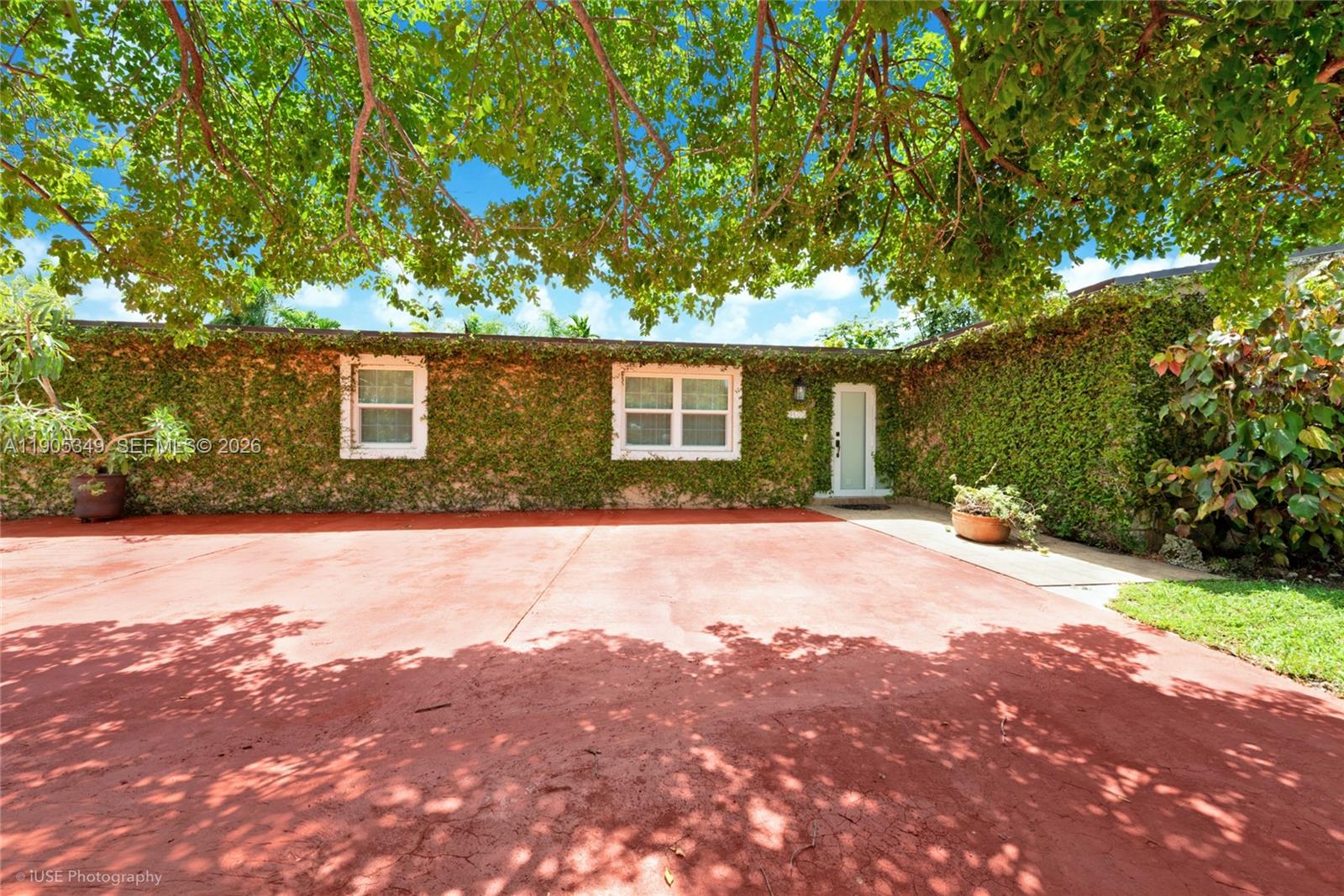 9500 Southwest 79th Street Miami, FL 33173 - Photo 1 of 19 a front view of a house with a yard and garage