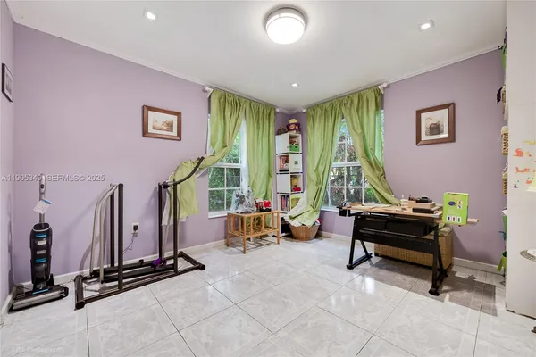 a bedroom with a bed a bookshelf a desk and chair