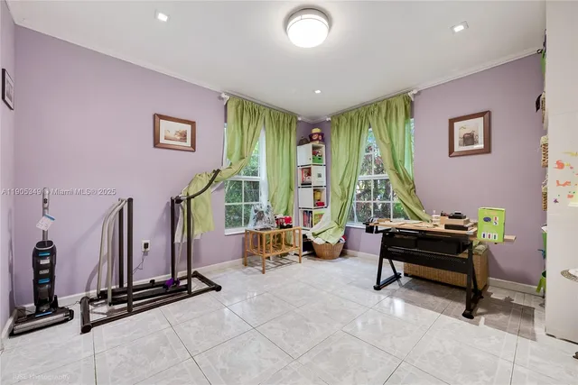 a living room with furniture gym equipment and a large window