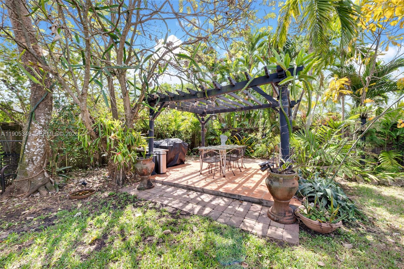 9500 Southwest 79th Street Miami, FL 33173 - Photo 17 of 19 a view of a chair and table in backyard
