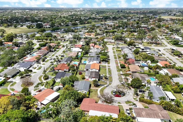 an aerial view of residential houses with outdoor space
