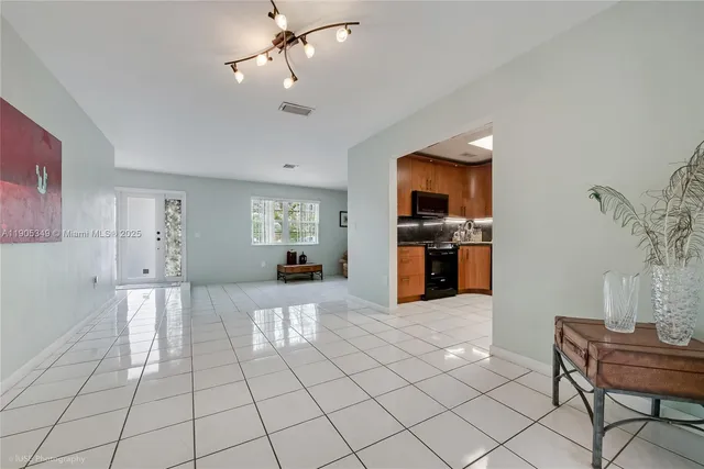 a large white kitchen with cabinets and a stove
