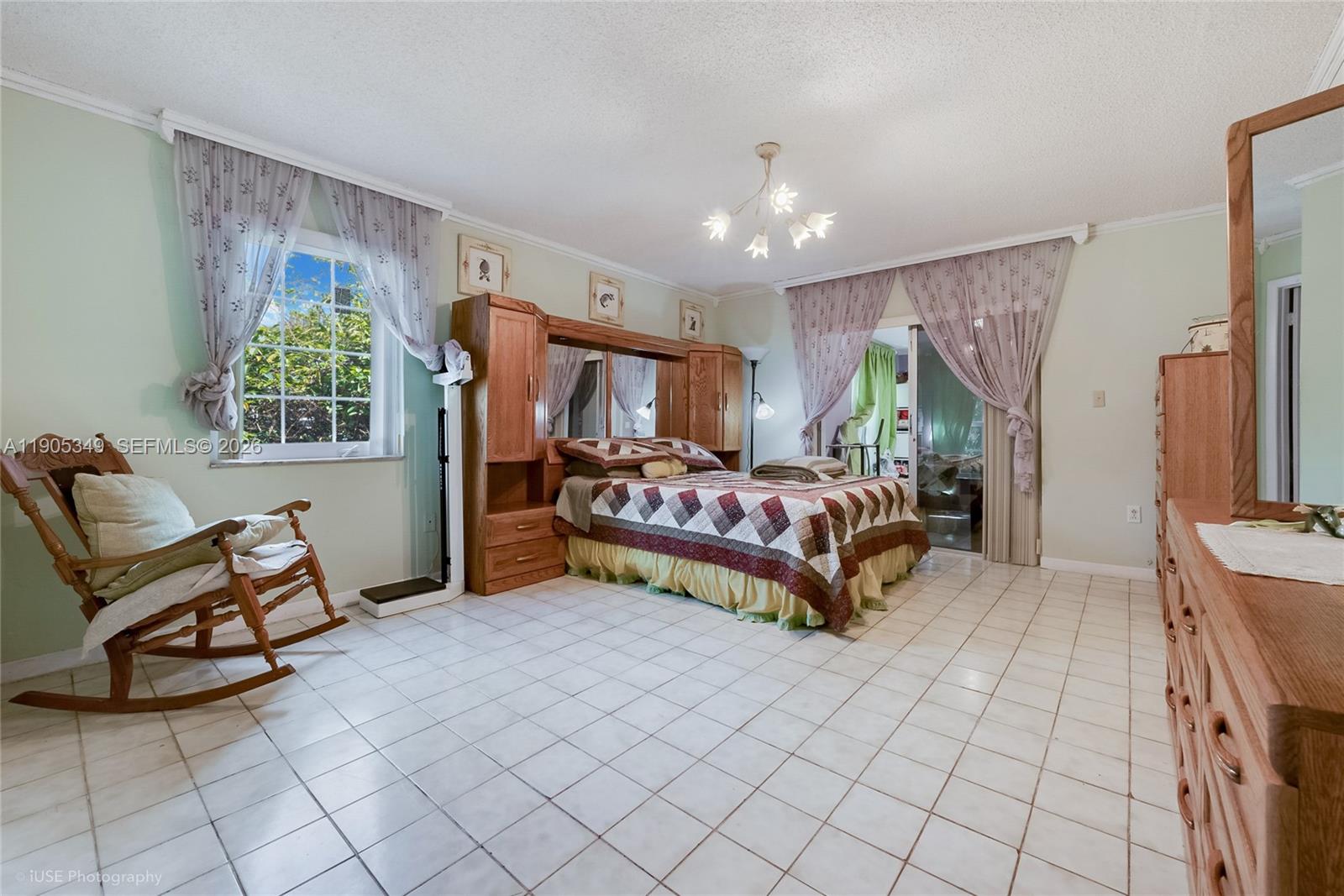 9500 Southwest 79th Street Miami, FL 33173 - Photo 7 of 19 a bedroom with furniture and a large window
