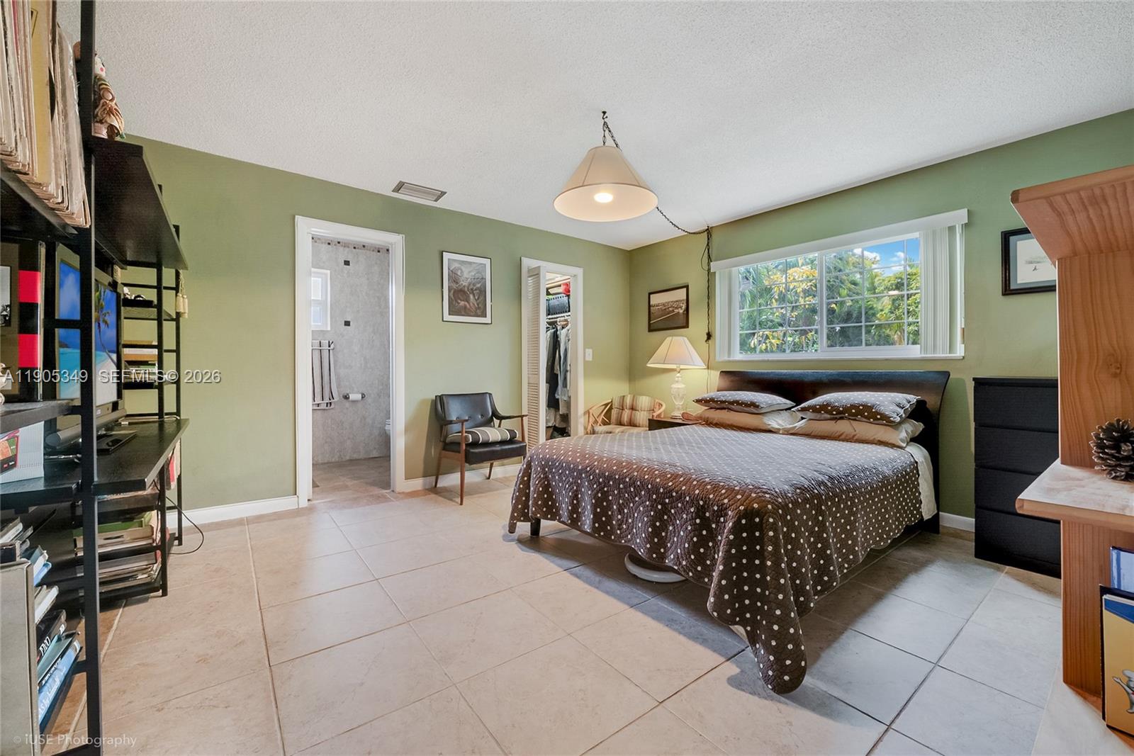 9500 Southwest 79th Street Miami, FL 33173 - Photo 8 of 19 a bedroom with a bed a bookshelf a desk and chair