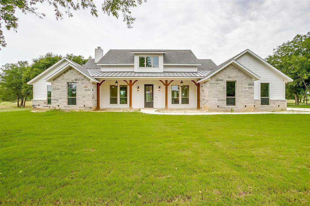 a front view of house with yard and green space