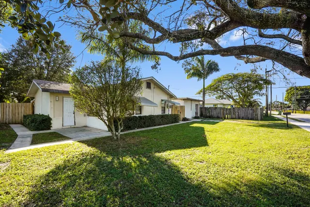 a house view with a swimming pool and garden
