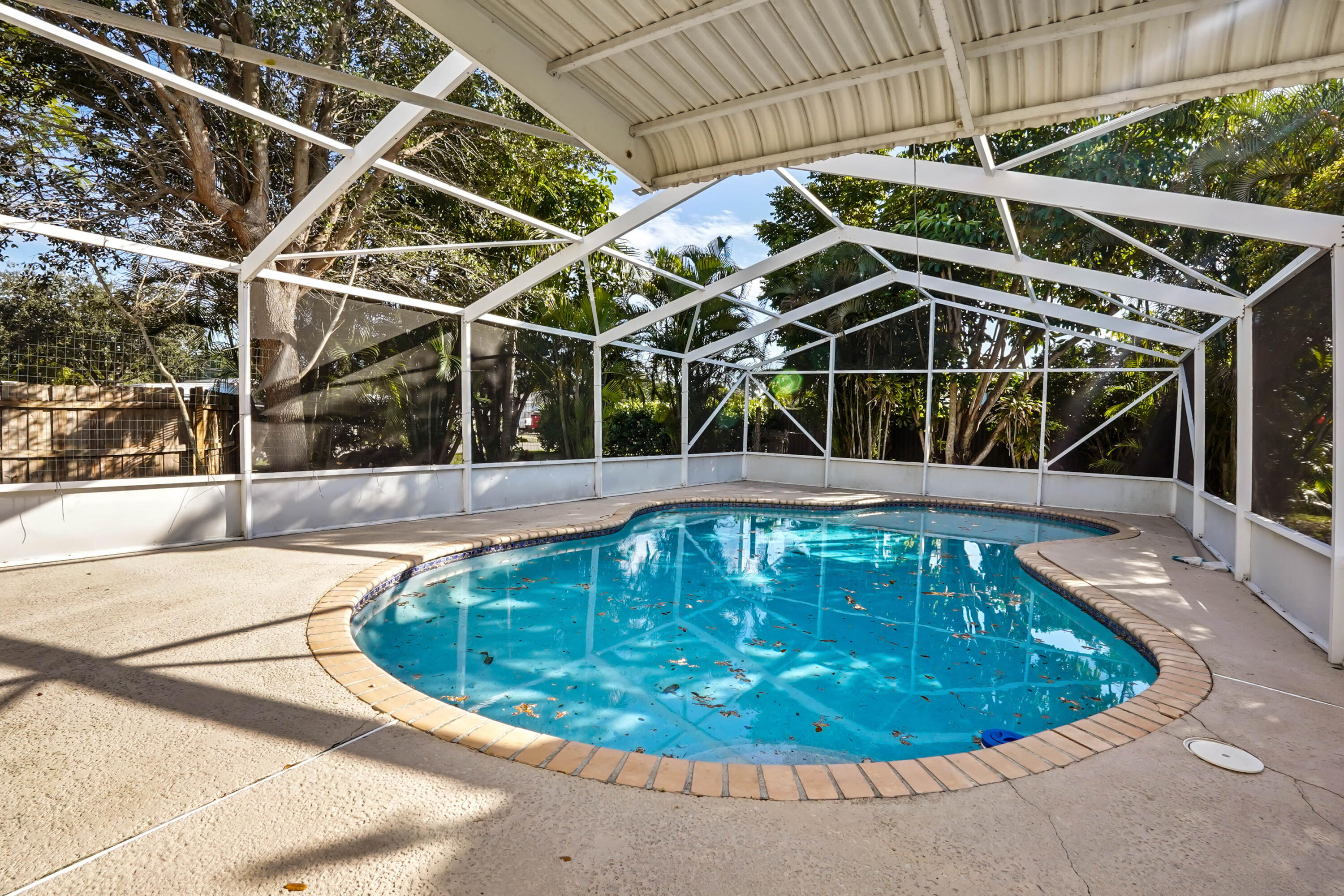 3858 Lakewood Road Palm Springs, FL 33461 - Photo 20 of 40 a view of a swimming pool with a patio