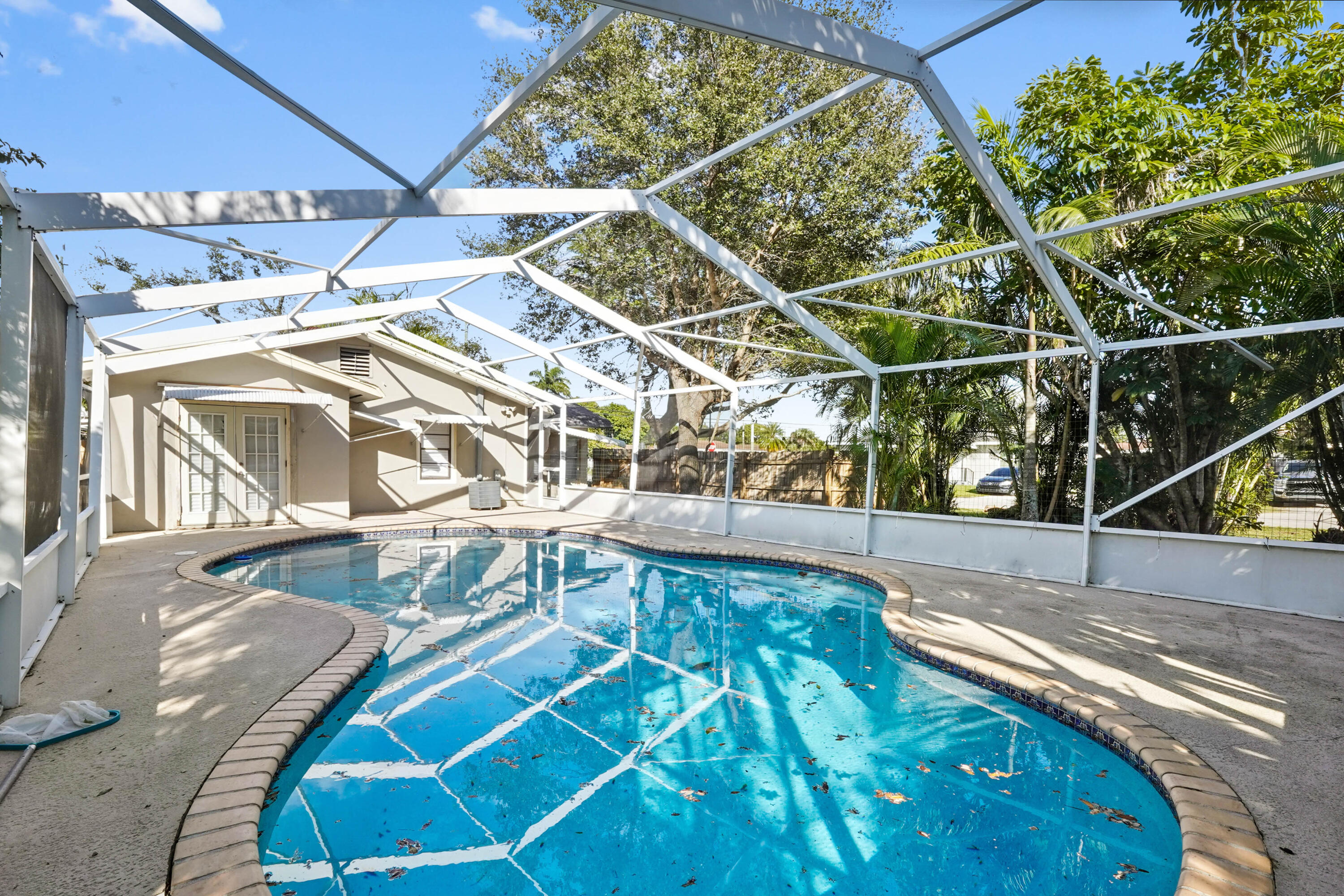 3858 Lakewood Road Palm Springs, FL 33461 - Photo 21 of 40 a view of a backyard with table and chairs