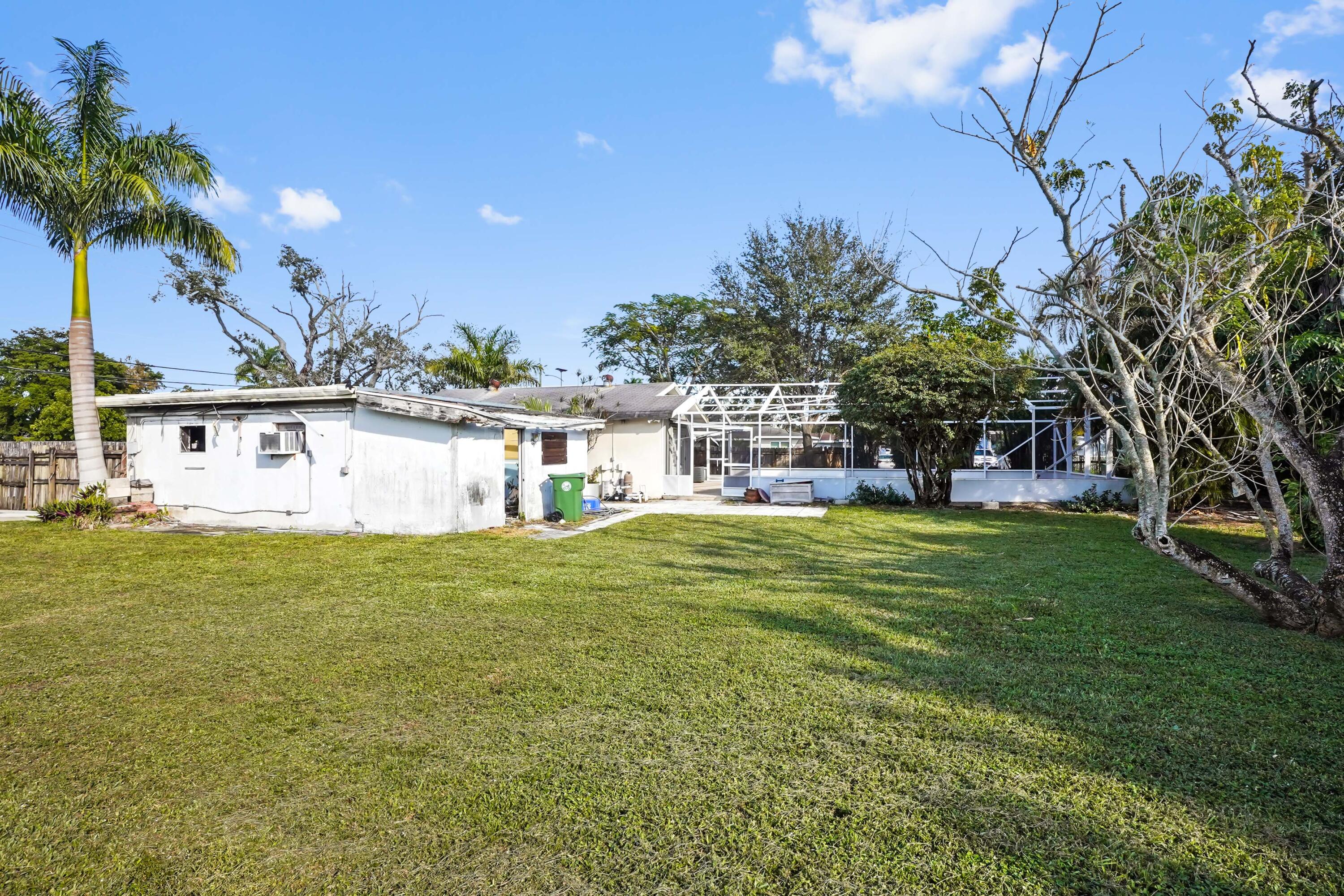 3858 Lakewood Road Palm Springs, FL 33461 - Photo 28 of 40 a front view of house with yard and seating area