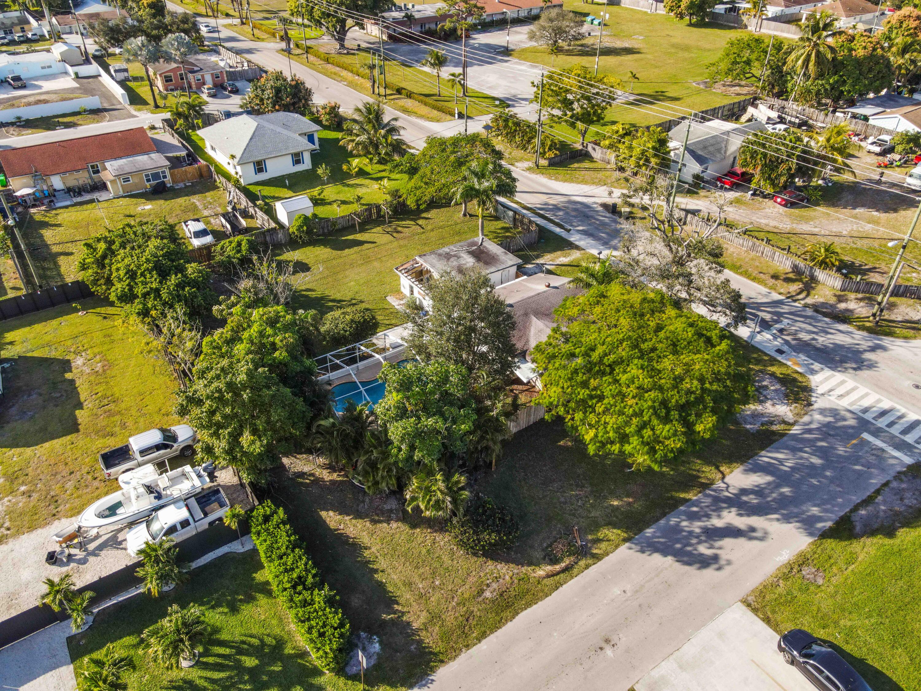 3858 Lakewood Road Palm Springs, FL 33461 - Photo 34 of 40 an aerial view of residential houses with outdoor space