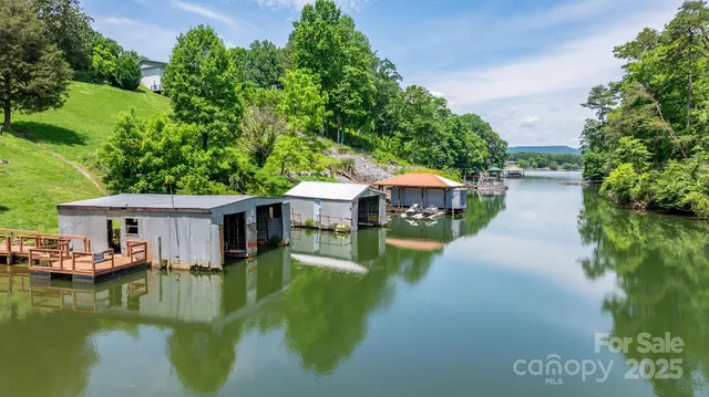 a aerial view of a house with swimming pool and lake view